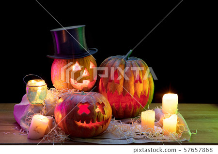 Halloween pumpkin head jack lantern with scary evil faces and candles Halloween pumpkin head jack lantern with scary evil faces and candles 57657868