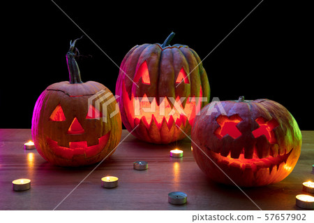 Halloween pumpkin head jack lantern with scary evil faces and candles Halloween pumpkin head jack lantern with scary evil faces and candles 57657902