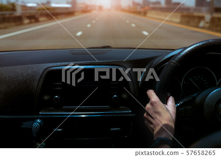 Driver hand holding steering wheel for control 57658265