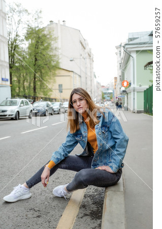 Blonde girl is walking on city street Blonde girl is walking on city street 57659257