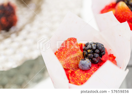Red delicious muffin with blackberries and blueberries. Candy bar with a lot of desserts, meringue 57659856