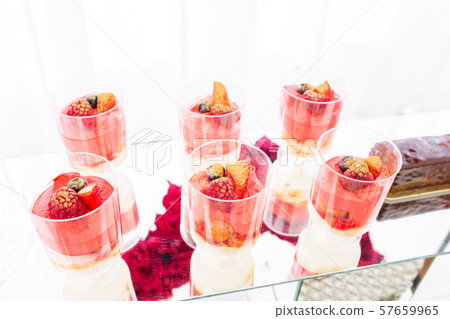 Candy bar with a lot of desserts, meringue, cupcake, fruit and sweet cakes. Sweet table for birthday 57659965