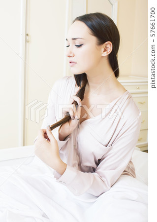 young pretty brunette woman laying in bed alone waiting sexy, lifestyle people concept 57661700