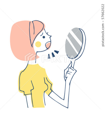 A woman looking at her mouth in the mirror 57662022