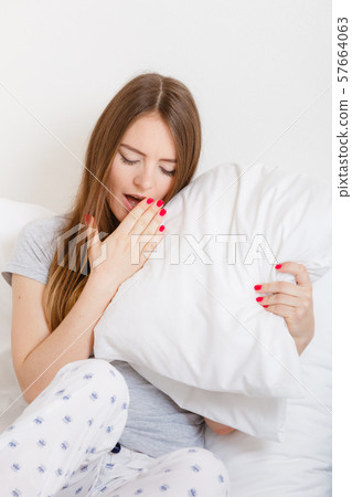 Young girl yawning. 57664063