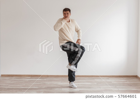 Young funny guy dancer shows his skills standing Young funny guy dancer shows his skills standing 57664601