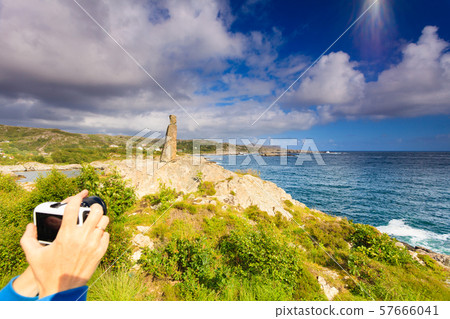 Woman tourist taking photo with camera in Norway Woman tourist taking photo with camera in Norway 57666041