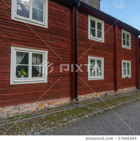 Fragment of old, wooden, red house and street. Fragment of old, wooden, red house and street. 57666884