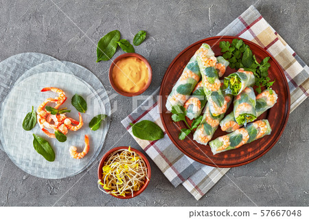 fresh raw Asian spring rolls on a plate fresh raw Asian spring rolls on a plate 57667048