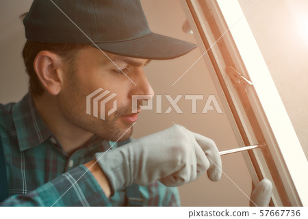 Doing it right. Man is installing a window 57667736