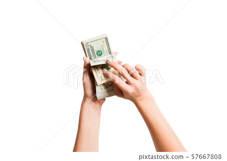 Top view of a bundle of money in female hands. 57667808