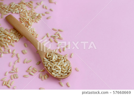 Brown rice in a wooden spoon 57668669