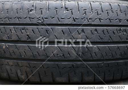 close up old damaged and worn black tire tread truck. 57668697