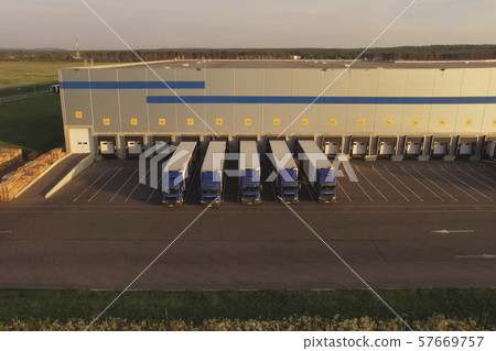 large warehouse complex with parked trucks awaiting loading. Logistics center, warehouse terminal large warehouse complex with parked trucks awaiting loading. Logistics center, warehouse terminal 57669757