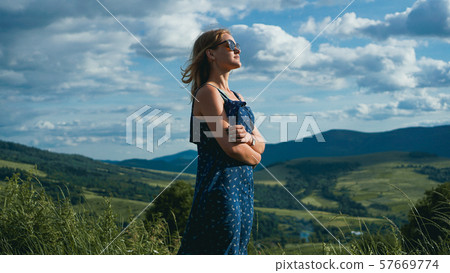Happy Woman in mountains at sunny day time 57669774