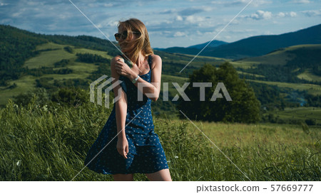 Happy Woman in mountains at sunny day time Happy Woman in mountains at sunny day time 57669777