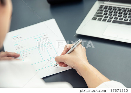 Businesswoman signs an invoice Businesswoman signs an invoice 57671310