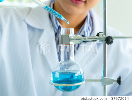 Young female doing experiments and researchers Young female doing experiments and researchers 57672014