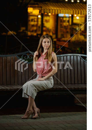 Nice girl on a bench in the evening in the park. Nice girl on a bench in the evening in the park. 57672613