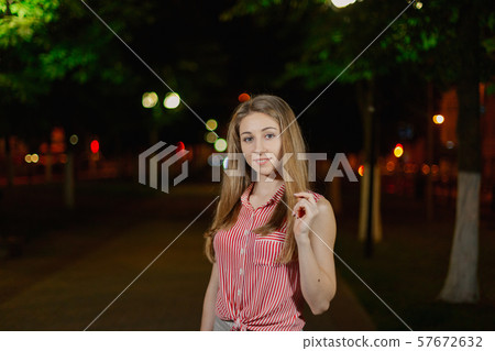 Beautiful girl in the alley in the park in the Beautiful girl in the alley in the park in the 57672632
