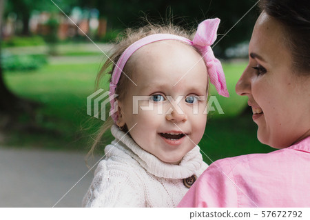 Children walk in the park on a day off. The sun is Children walk in the park on a day off. The sun is 57672792