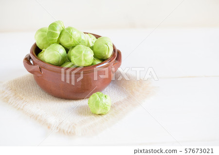 a pile of Brussels sprouts on a white wooden a pile of Brussels sprouts on a white wooden 57673021