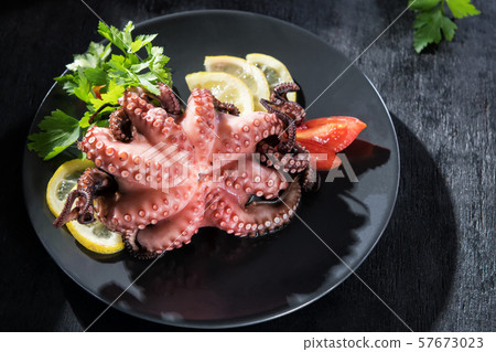 Stuffed octopus in white wine with lemon and Stuffed octopus in white wine with lemon and 57673023
