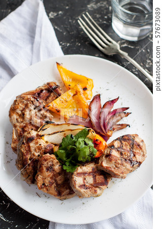 Grilled pork sirloin with vegetables 57673089