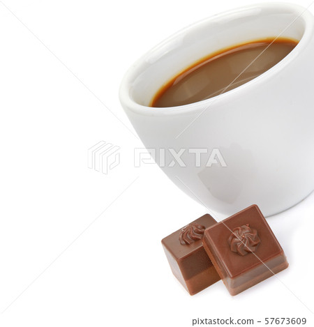 Cup of coffee and chocolate candies on white Cup of coffee and chocolate candies on white 57673609