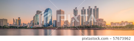 Skyscrapers Reflected in a Lake at Sunrise 57673962