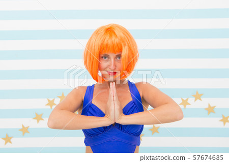 namaste. crazy girl with orange hair practicing 57674685