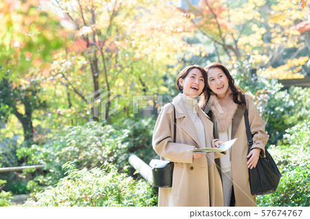 Travel autumn autumn leaves mother daughter parent and child family travel image 57674767