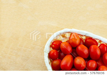 basket tomatoes on a light beige background. base basket tomatoes on a light beige background. base 57676036