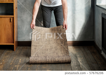 Closeup of senior man rolling mat before practicing yoga 57676206