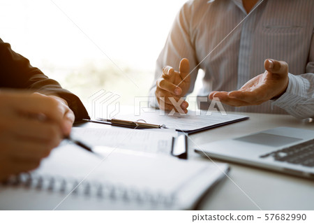 Male employee is explaining to the manager while 57682990