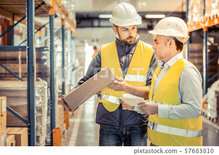 Serious young manager consulting his competent colleague 57683810