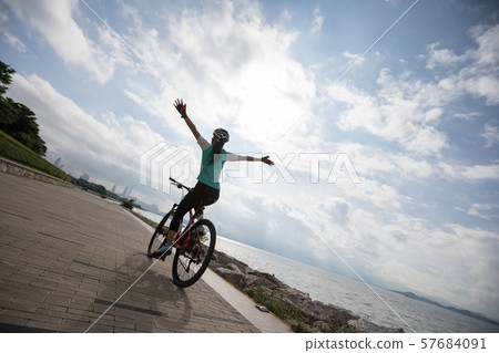 Hands free cycling woman riding Mountain Bike on 57684091