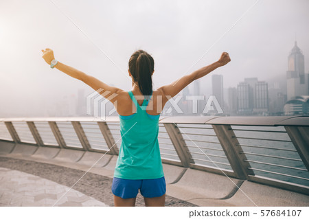 Healthy lifestyle woman runner outstretched arms Healthy lifestyle woman runner outstretched arms 57684107