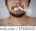 messy bearded man with white smoke from mouth onto 57684205