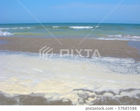 Water pollution, dirty foam on the beach 57685598