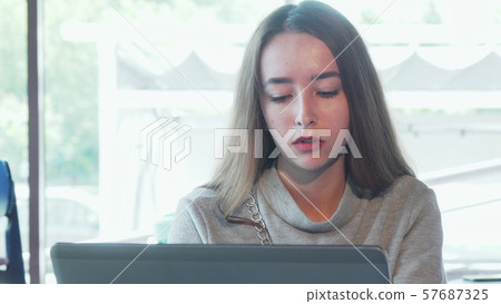 Beautiful woman looking stressed while working on laptop 57687325