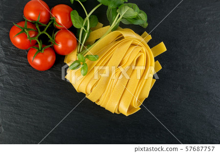 Raw yellow italian pasta pappardelle, fettuccine Raw yellow italian pasta pappardelle, fettuccine 57687757
