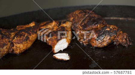 Close up of hot and tasty meat preparing on grill Close up of hot and tasty meat preparing on grill 57687781