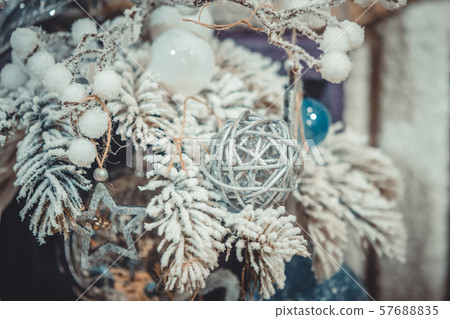 Christmas tree toys decorations and snow-covered Christmas tree branches 57688835