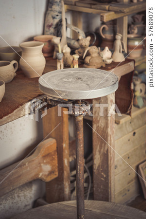 Pottery studio, empty potter's wheel, pottery from clay Pottery studio, empty potter's wheel, pottery from clay 57689078