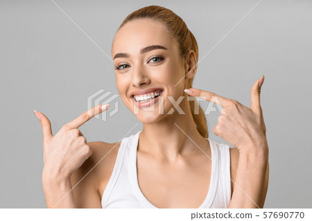 Orthodontic concept. Happy girl showing her beaming white teeth 57690770