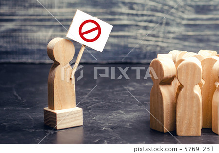 A man with a poster agitates a group of people. Voters, the political process movement. Social tension, strike. Drawing public attention to the corruption problem. Populism. struggle for rights A man with a poster agitates a group of people. Voters, the political process movement. Social tension, strike. Drawing public attention to the corruption problem. Populism. struggle for rights 57691231