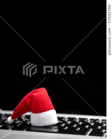 Santa Claus Hat on laptop keyboard. Searching Santa Claus Hat on laptop keyboard. Searching 57692760