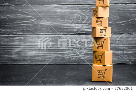 Tower of cardboard boxes with pattern of shopping carts. Purchasing power, delivery order. Sales of goods and services. E-commerce, logistics, distribution. commerce, online shopping. Copy space 57692861
