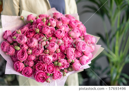 Flowers pink color, peony roses, misty bubbles. Beautiful bouquets in woman hand. Floral shop Flowers pink color, peony roses, misty bubbles. Beautiful bouquets in woman hand. Floral shop 57693496